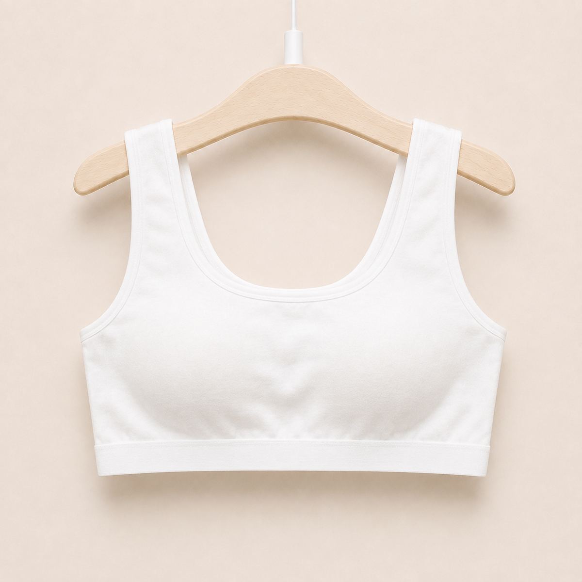The Cotton One in white on a hanger - wire-free cotton training bra for girls