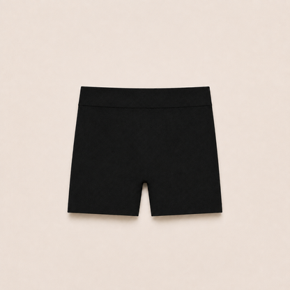 Gently Play Shorts in black, seamless under-skirt shorts for girls, laid flat