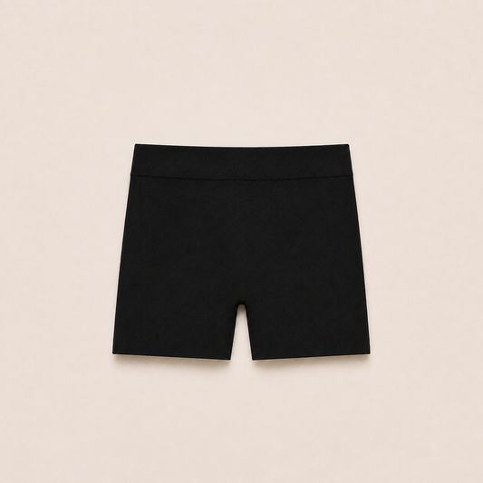 Gently Play Shorts in black, seamless under-skirt shorts for girls, laid flat